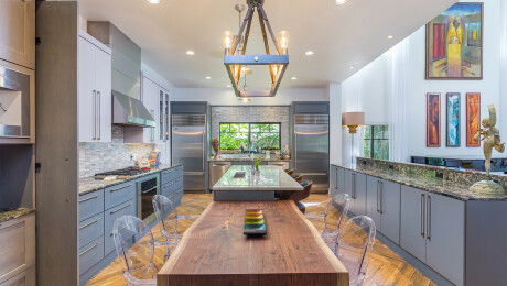 Large designer kitchen boasting two islands, herringbone floors, and marble backsplashes, St. Petersburg FL
