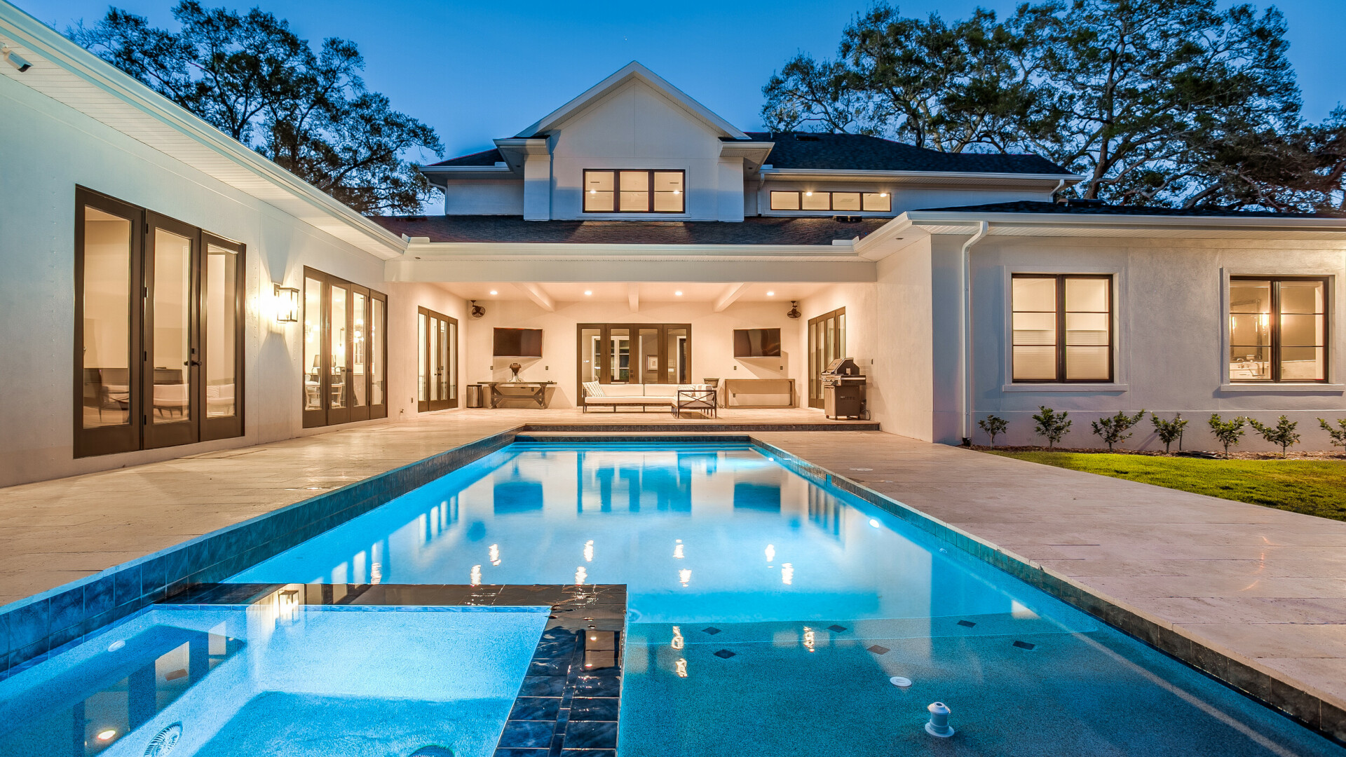 Modern home featuring a large outdoor living space, pool, and hot tub, St. Petersburg FL